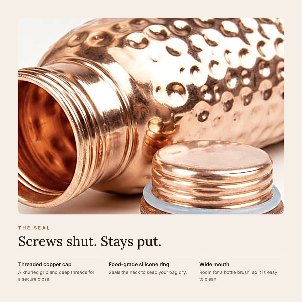 Close-up of the copper bottle's threaded cap with food-grade silicone seal and wide mouth